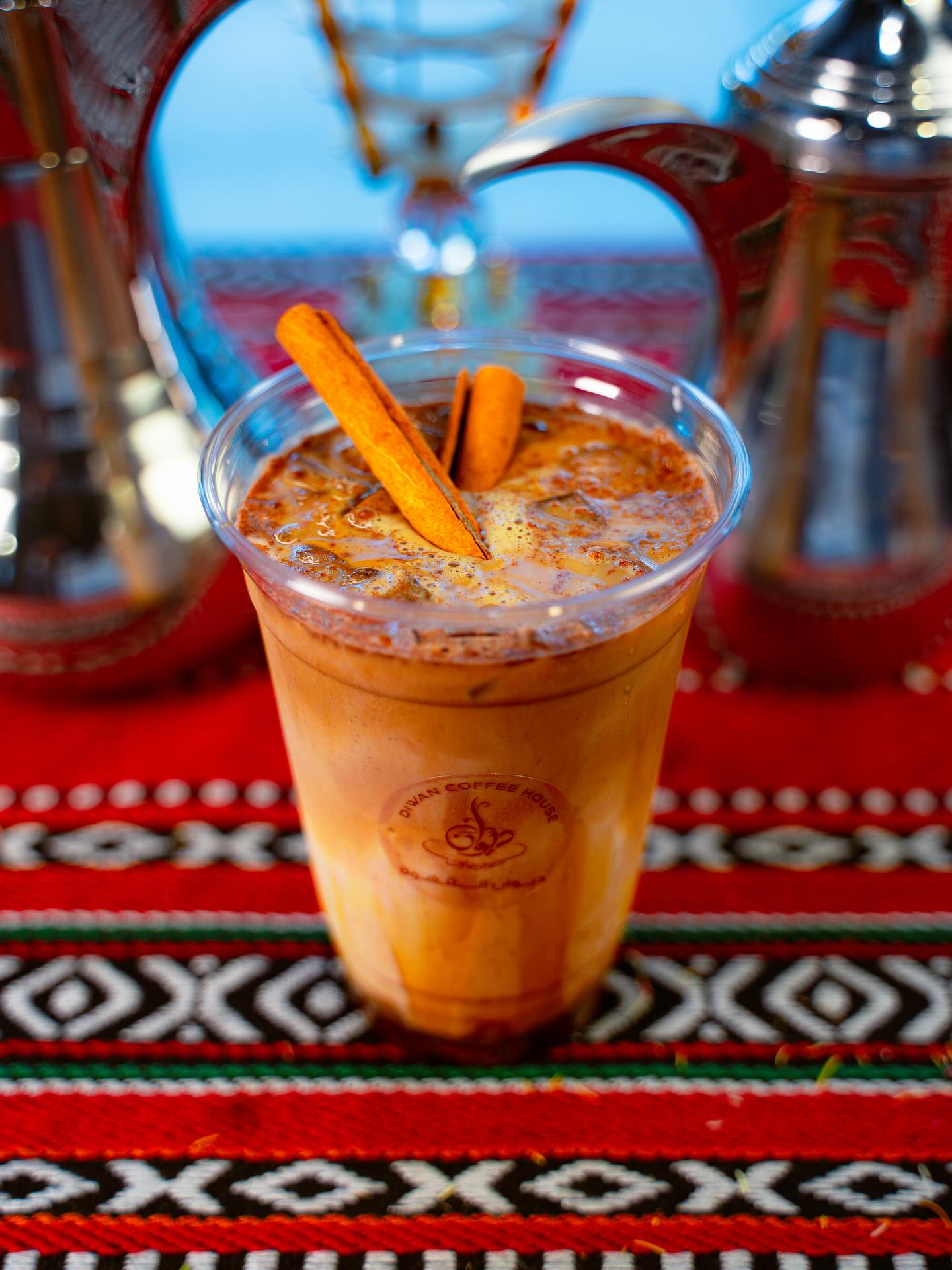 Iced cinnamon spice latte on Palestinian textile
