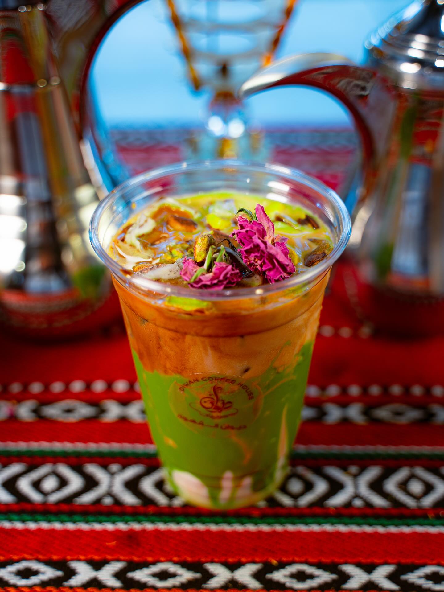 Diwan Coffee House signature drinks lineup on Palestinian textile